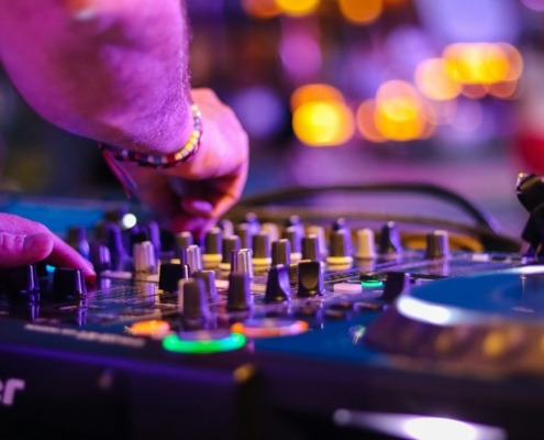 DJ controlling turntable at night