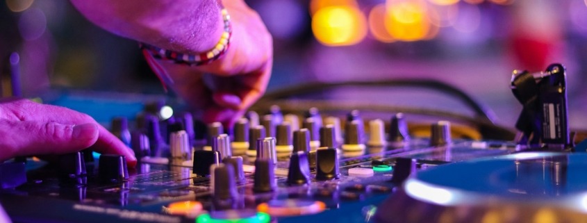 DJ controlling turntable at night