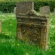 gray concrete tomb on green grass field during daytime